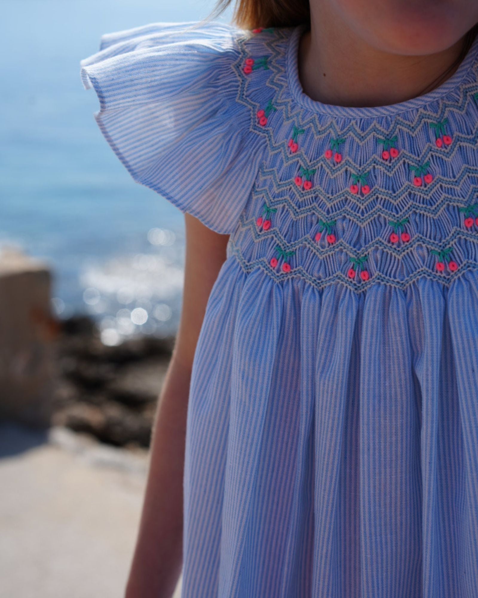 Indira Gandhi Flutter Dress Baby Blue Seersucker with Cherries Hand Smocking